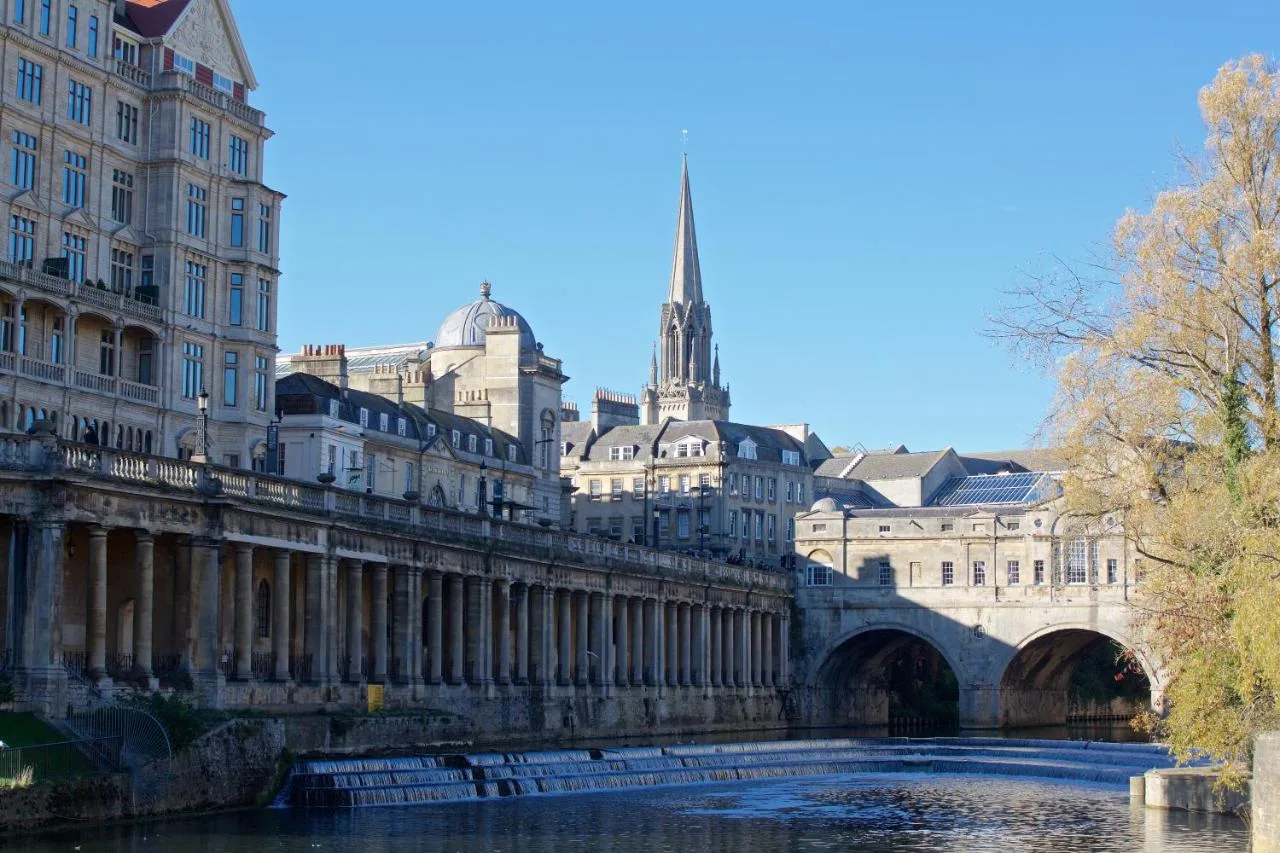a bridge over a river in front of buildings at The Z Hotel Bath in Bath